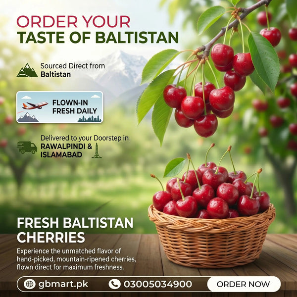 Fresh organic cherries from Baltistan displayed in a basket, showcasing vibrant red cherries on a rustic wooden table.